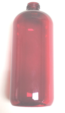 a red plastic bottle is sitting on a white surface .